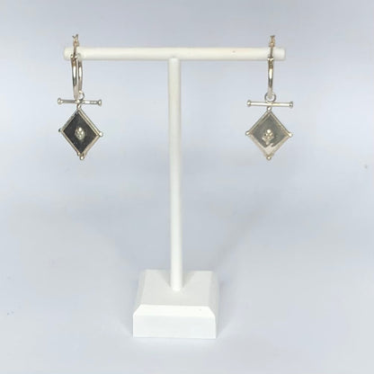 Pair of silver diamond shaped earrings 